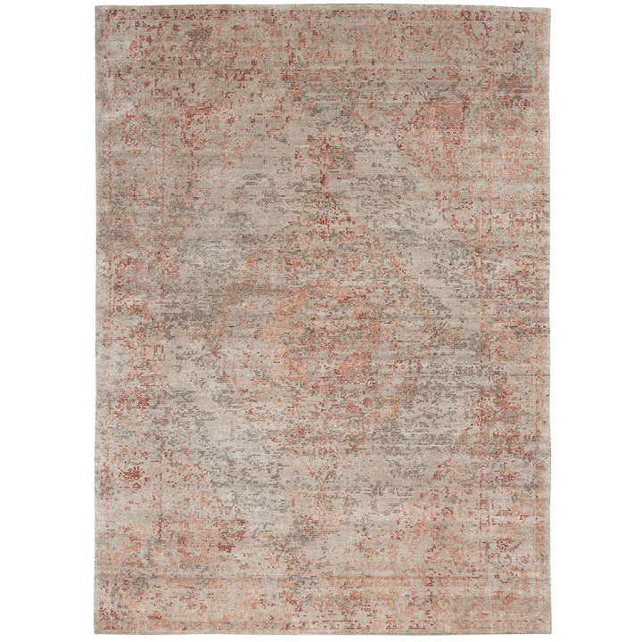 Distressed rectangular area rug with faded red vintage design motif.