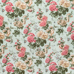 Traditional floral fabric with clusters of pink roses on aqua.