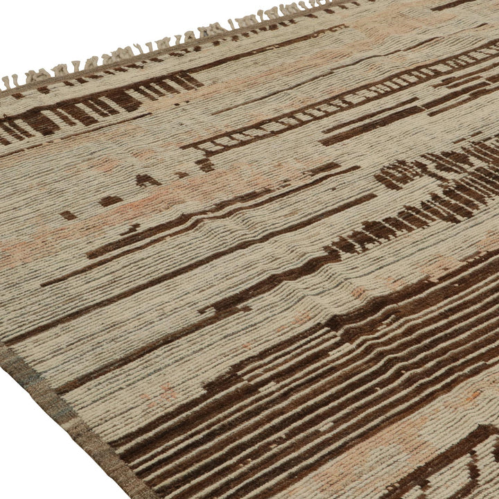 Handcrafted wool rug with neutral tones and tribal-inspired pattern design.