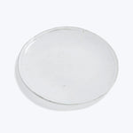 Clear petri dish with minor imperfections on plain white background.